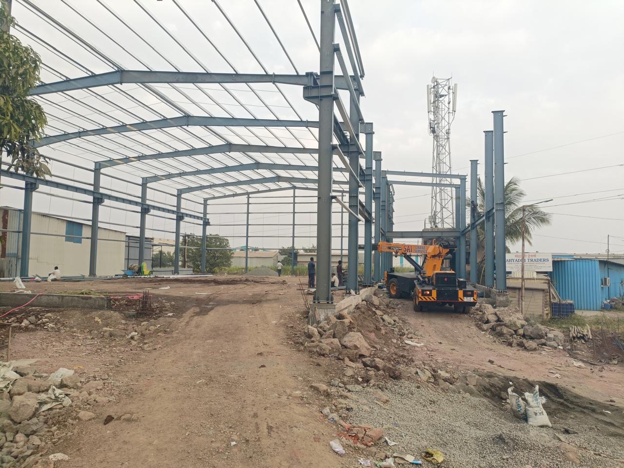 Mobile crane erecting steel frame members on site