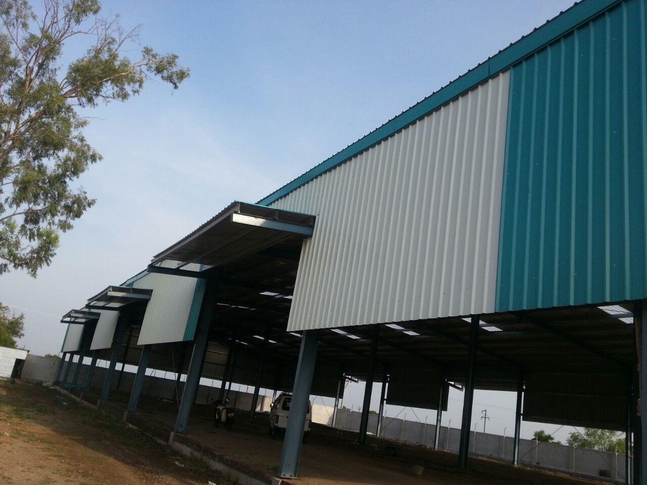 Completed multi-bay industrial warehouse with cantilevered canopies